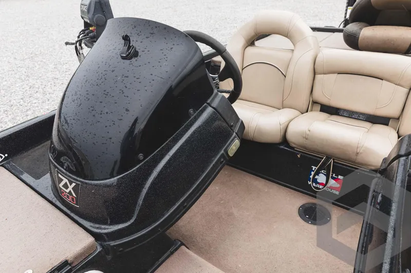 Slide: The Image of 2009 Skeeter ZX 200 boat interior with steering console and beige seats. - 38