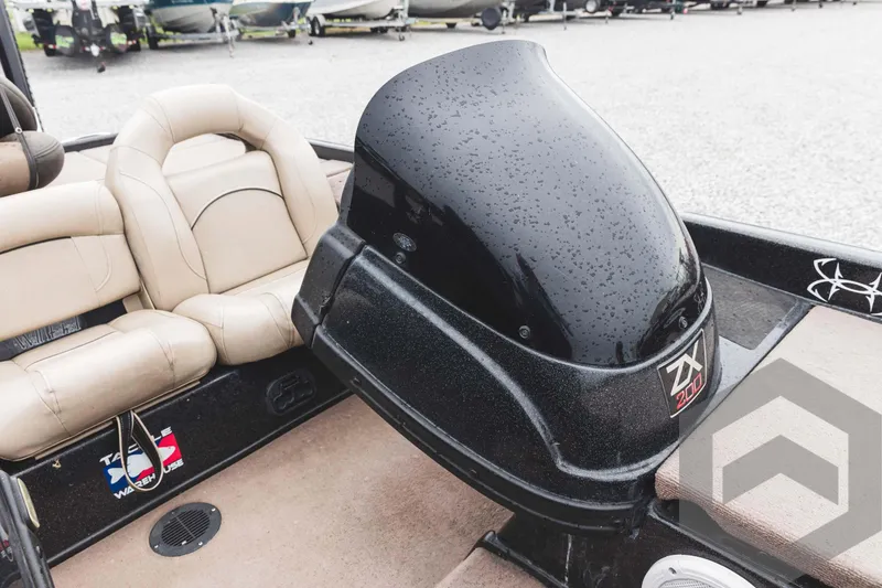 Slide: The Image of 2009 Skeeter ZX 200 boat interior with beige seats and black motor. - 39