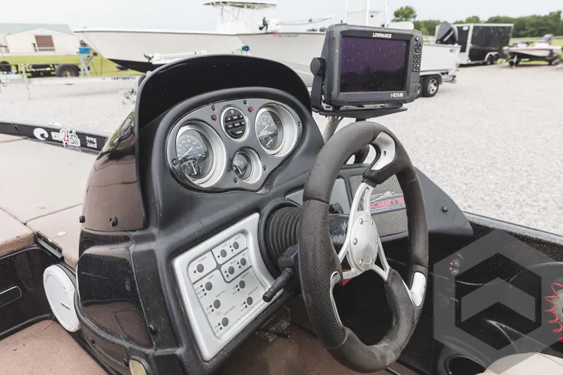 Slide: The Image of 2009 Skeeter ZX 200 boat dashboard with steering wheel and navigation system. - 44