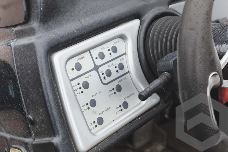 Slide: The Image of 2009 Skeeter ZX 200 boat control panel with various switches and buttons. - 46