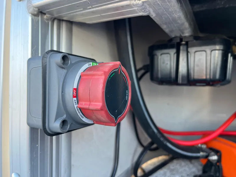 Slide: The Image of Red power switch in a Nepallo CW18, 2022 model, with visible wiring. - 13