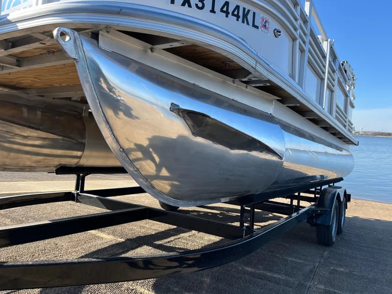 Slide: The Image of 2022 Nepallo CW18 pontoon boat on trailer by the water. - 2