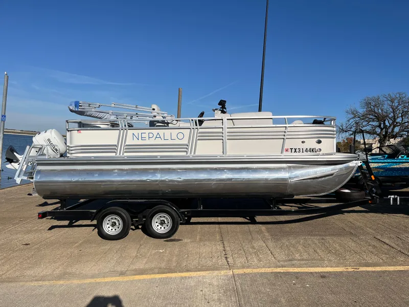 Slide: The Image of 2022 Nepallo CW18 pontoon boat on trailer, parked on concrete surface. - 20