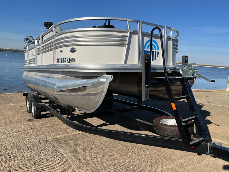 Slide: The Image of 2022 Nepallo CW18 pontoon boat on trailer by the water. - 22