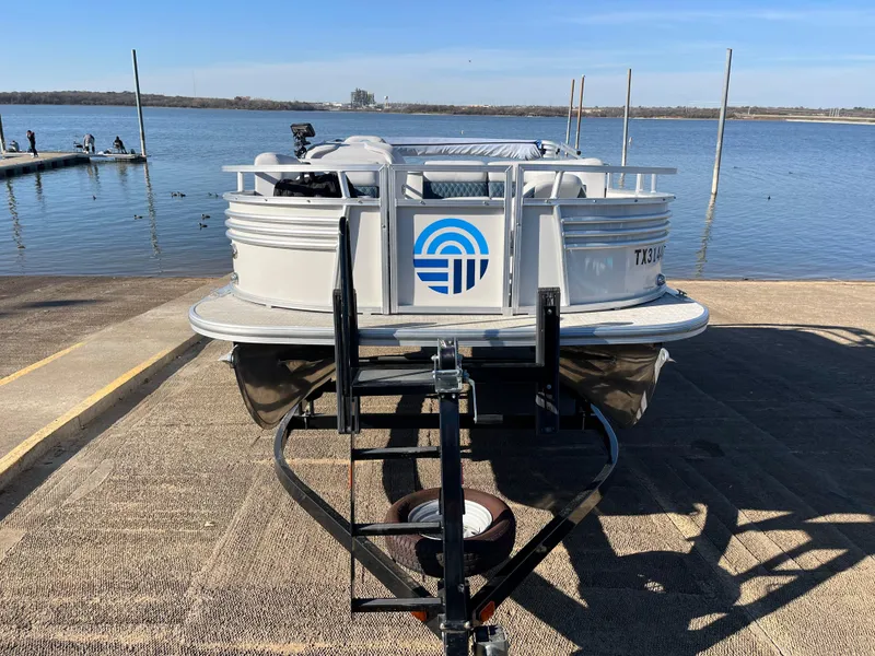 Slide: The Image of Nepallo CW18 pontoon boat on trailer by a lake, 2022 model. - 24