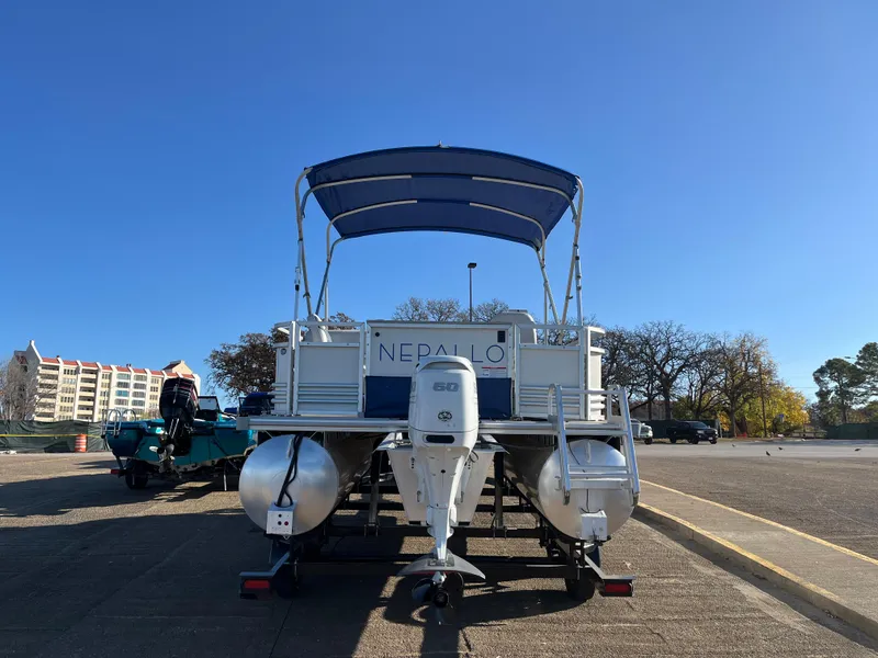 Slide: The Image of 2022 Nepallo CW18 pontoon boat with canopy and outboard motor in a parking lot. - 28
