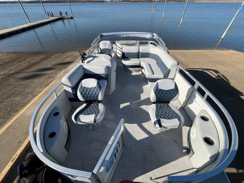 Slide: The Image of Nepallo CW18 2022 pontoon boat interior with seating, docked by a serene lake. - 33