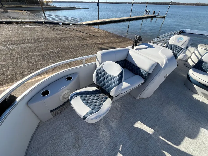 Slide: The Image of Nepallo CW18 2022 boat interior with quilted seating by a serene lake. - 34