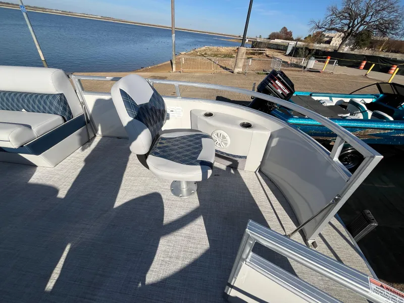 Slide: The Image of Nepallo CW18 2022 boat interior with seating, near a calm waterfront. - 35