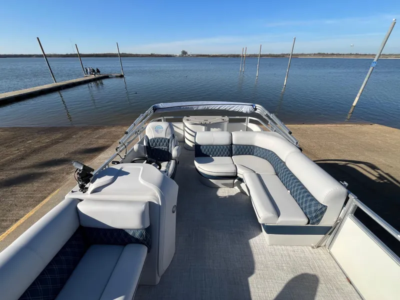 Slide: The Image of Nepallo CW18 2022 pontoon boat with spacious seating, docked by a serene lake. - 36
