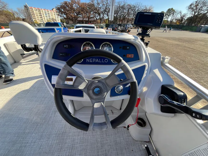 Slide: The Image of Nepallo CW18 2022 boat dashboard with steering wheel and controls in outdoor setting. - 39