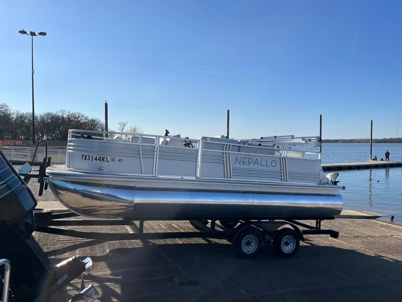 Slide: The Image of 2022 Nepallo CW18 pontoon boat on trailer by a lake. - 4