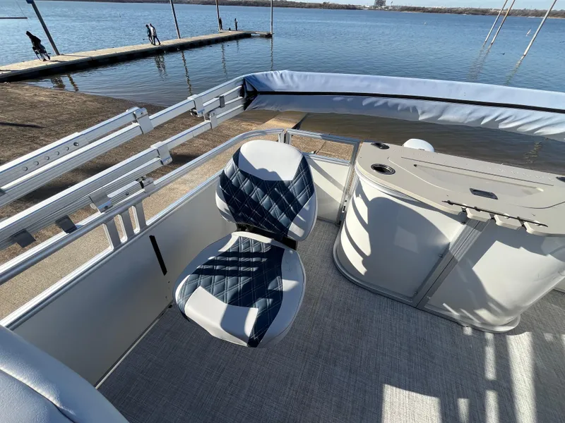 Slide: The Image of Nepallo CW18 2022 boat interior with blue and white seating, dockside view. - 40