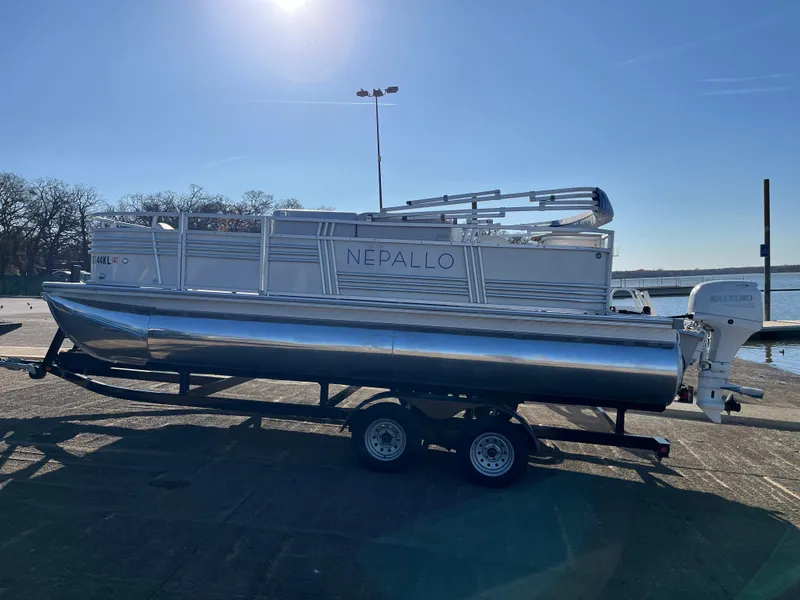 Slide: The Image of 2022 Nepallo CW18 pontoon boat on trailer under clear blue sky. - 5