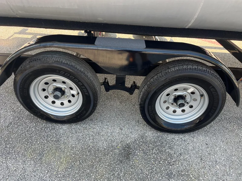 Slide: The Image of Dual wheels on a 2022 Nepallo CW18 trailer, parked on asphalt. - 52