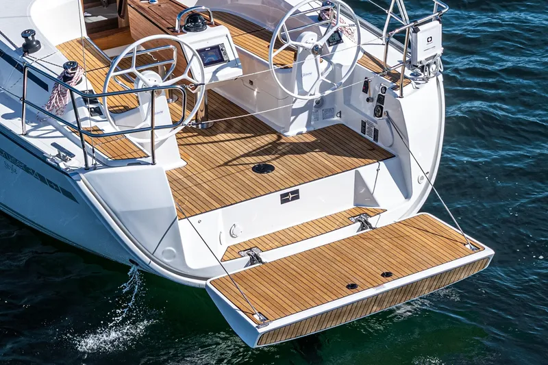 Slide: The Image of 2024 Bavaria Cruiser 34 yacht with dual steering wheels and teak deck. - 22