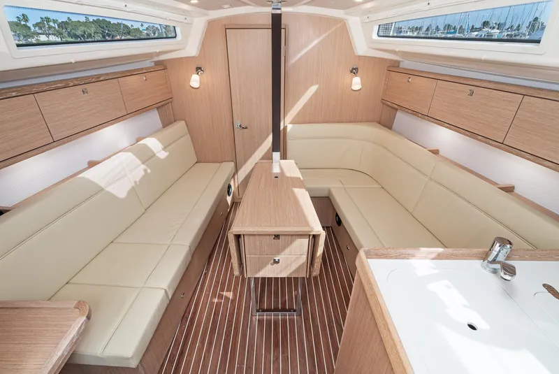 Slide: The Image of Interior of 2024 Bavaria Cruiser 34 sailboat with modern wood finish and beige seating. - 24