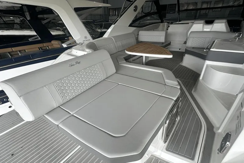 Slide: The Image of 2025 Sea Ray Sundancer 320 interior with luxurious seating and modern design. - 12