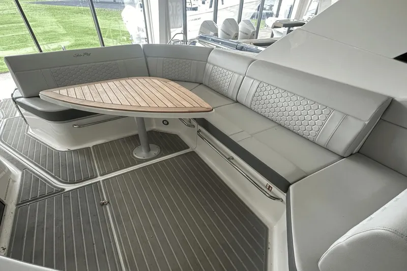 Slide: The Image of 2025 Sea Ray Sundancer 320 interior with sleek seating and wooden table. - 15