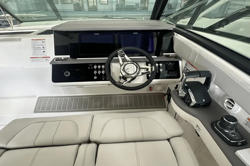 Slide: The Image of 2025 Sea Ray Sundancer 320 helm with modern controls and sleek design. - 18