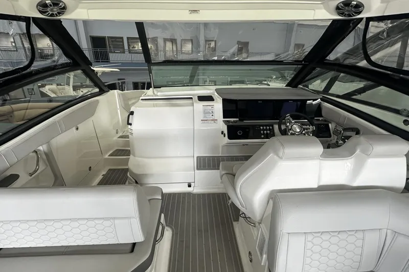 Slide: The Image of 2025 Sea Ray Sundancer 320 cockpit with modern helm and seating, featuring sleek design. - 19