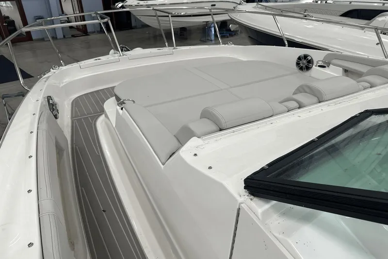 Slide: The Image of 2025 Sea Ray Sundancer 320 boat interior with cushioned seating and sleek design. - 6
