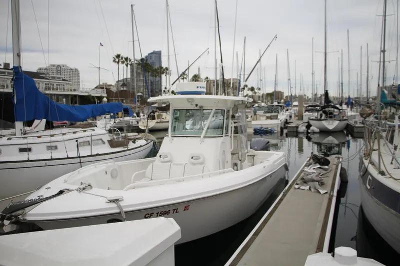 Slide: The Image of 2008 Everglades 270 Center Console boat docked in a marina. - 12