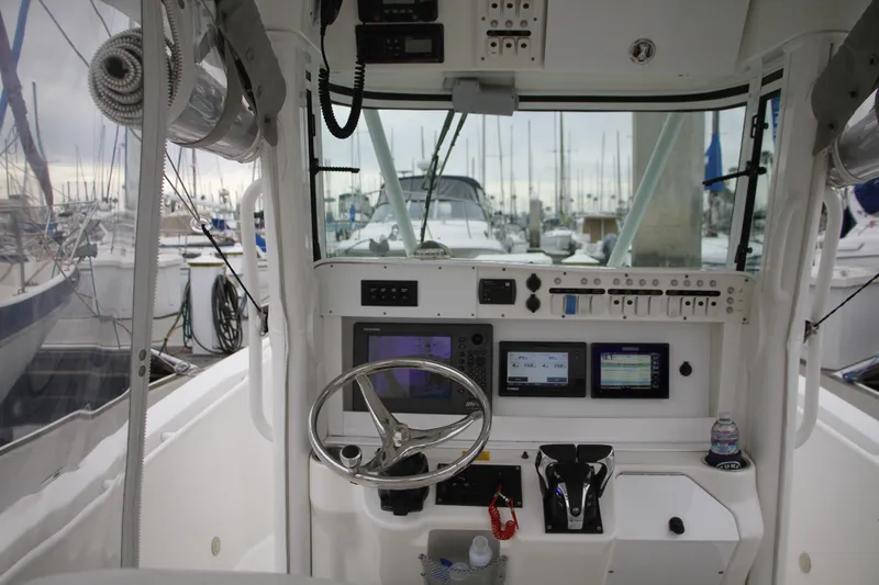 Slide: The Image of Center console of a 2008 Everglades 270 boat with navigation equipment and steering wheel. - 19