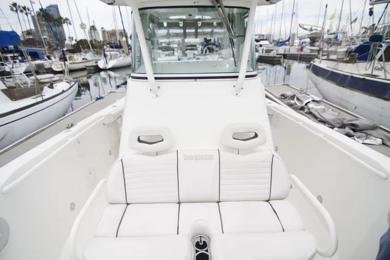 Slide: The Image of 2008 Everglades 270 Center Console boat with white seating, docked at a marina. - 21
