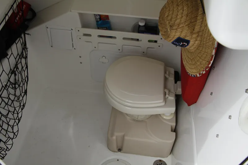 Slide: The Image of 2008 Everglades 270 Center Console boat interior with toilet and storage area. - 24