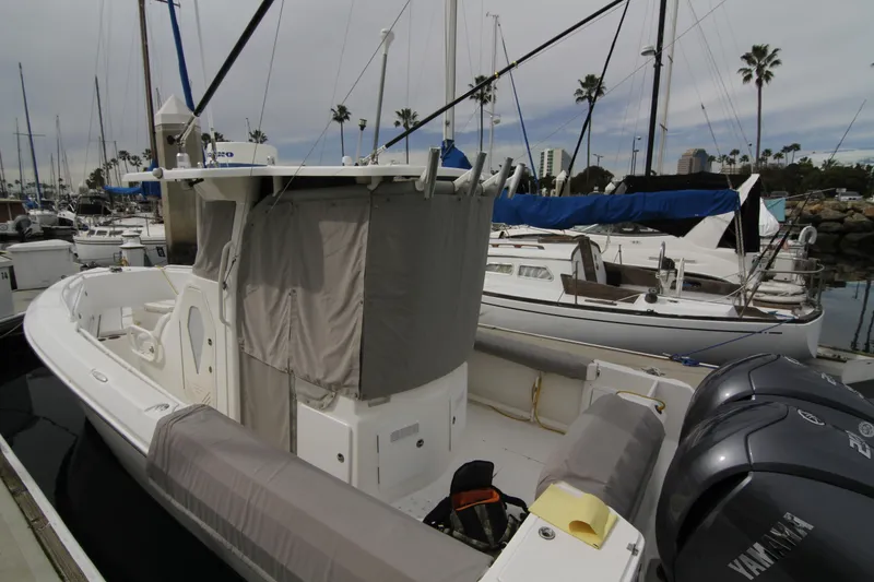 Slide: The Image of 2008 Everglades 270 Center Console boat docked in a marina with other vessels. - 25
