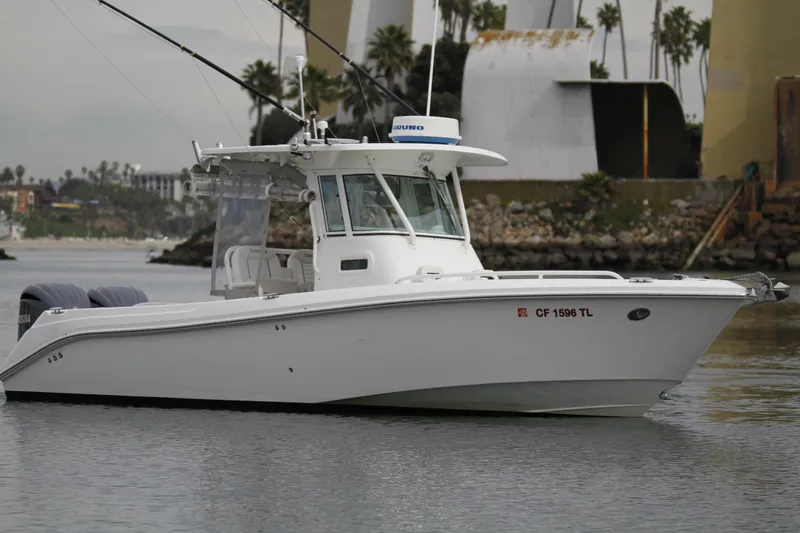 Slide: The Image of 2008 Everglades 270 Center Console boat on calm water, featuring dual engines. - 4