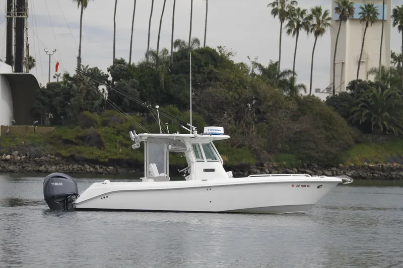 Slide: The Image of 2008 Everglades 270 Center Console boat on calm water, surrounded by lush greenery. - 7