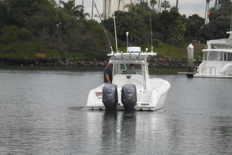 Slide: The Image of 2008 Everglades 270 Center Console boat on calm water with two people onboard. - 8
