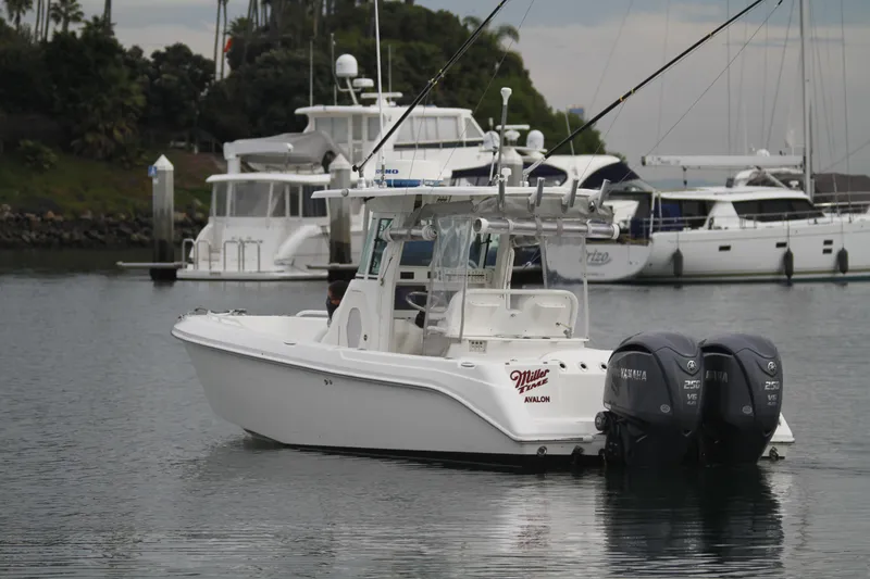 Slide: The Image of 2008 Everglades 270 Center Console boat docked in a marina with other vessels. - 9