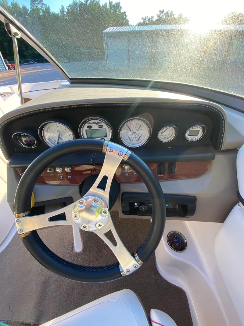 Slide: The Image of 2008 Four Winns F Series F244 boat dashboard with steering wheel and gauges. - 5
