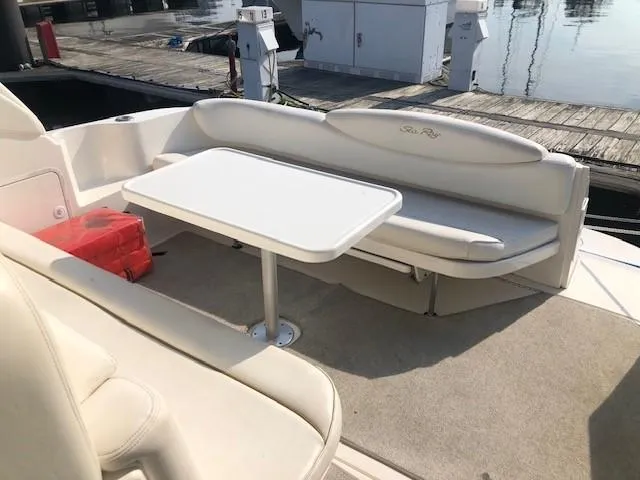 Slide: The Image of 2001 Sea Ray 340 Sundancer boat interior with seating and table at dock. - 11