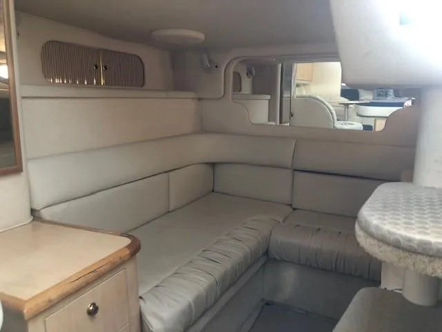 Slide: The Image of Interior of 2001 Sea Ray 340 Sundancer yacht with beige seating and wooden accents. - 21
