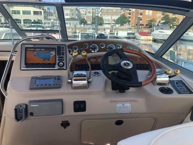 Slide: The Image of 2001 Sea Ray 340 Sundancer helm with navigation equipment and steering wheel. - 24