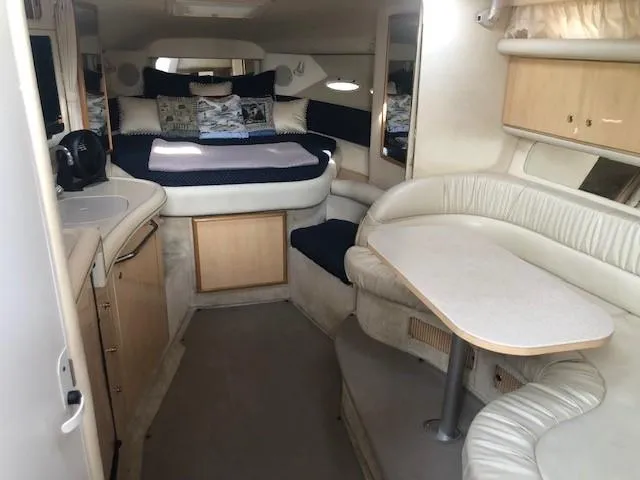 Slide: The Image of Interior of 2001 Sea Ray 340 Sundancer yacht with cozy seating and sleeping area. - 25