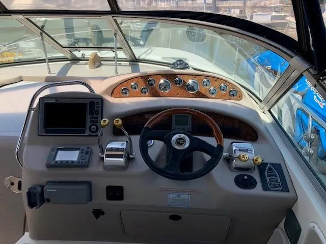 Slide: The Image of Helm of 2001 Sea Ray 340 Sundancer with navigation instruments and steering wheel. - 6