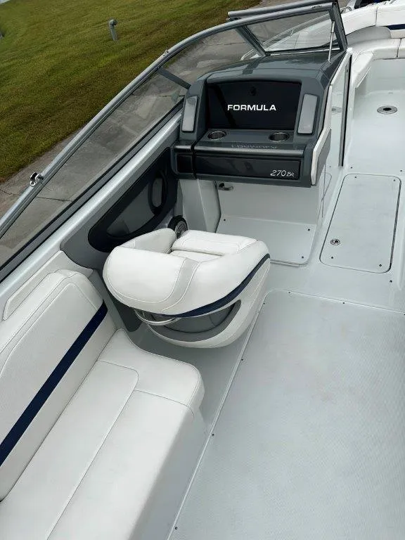 Slide: The Image of 2013 Formula 270 Bowrider boat interior with white seating and control panel. - 8