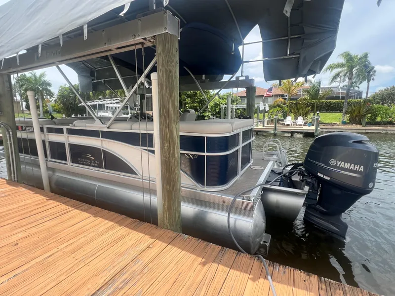 Slide: The Image of 2016 Bennington Sx pontoon boat with Yamaha outboard motor docked under canopy. - 1