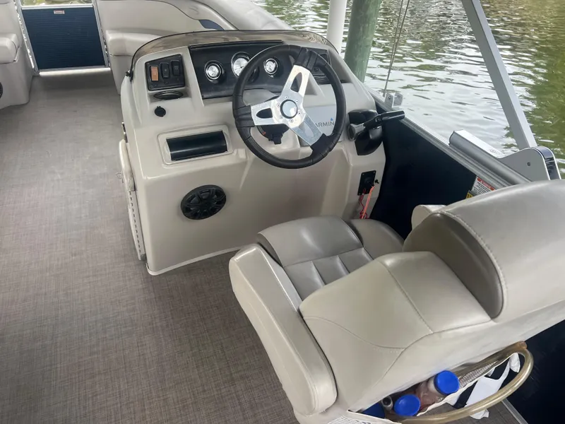 Slide: The Image of 2016 Bennington Sx boat helm with steering wheel and captain's chair. - 12