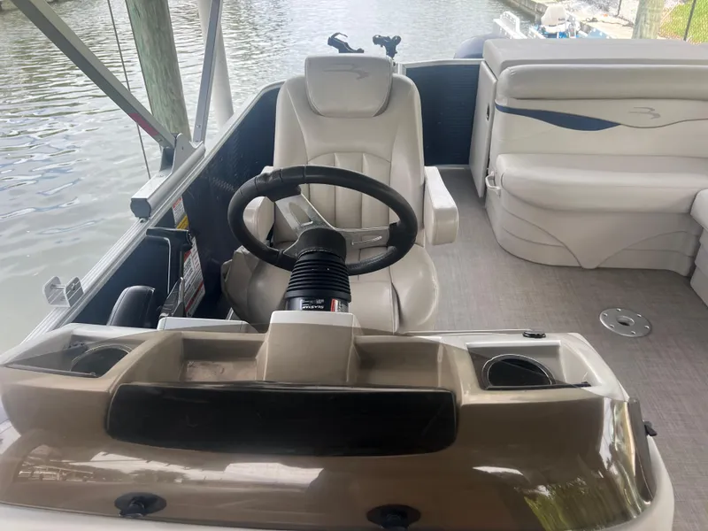 Slide: The Image of 2016 Bennington Sx boat interior with steering wheel and seating. - 13
