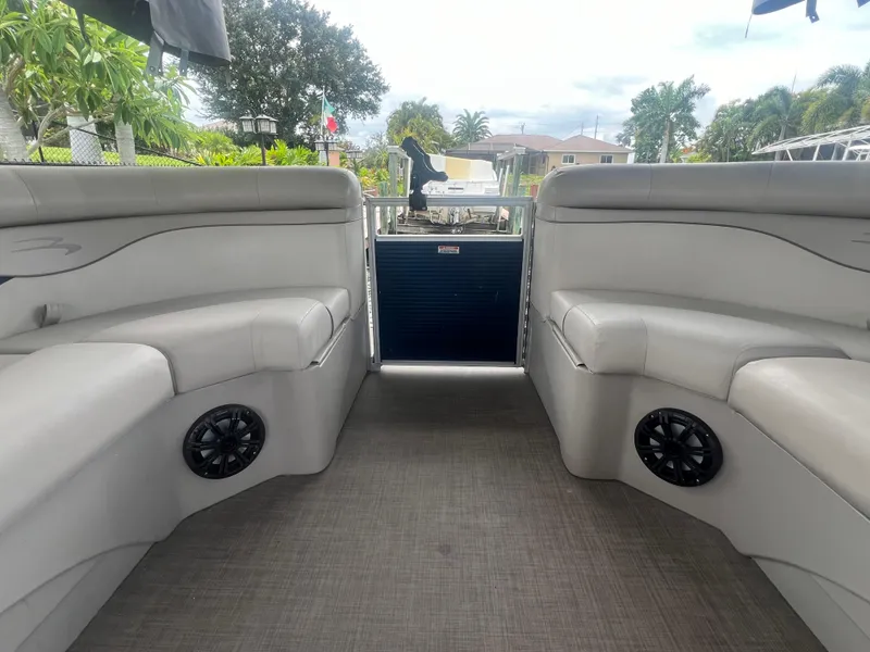 Slide: The Image of 2016 Bennington Sx boat interior with gray seating and black speakers. - 19