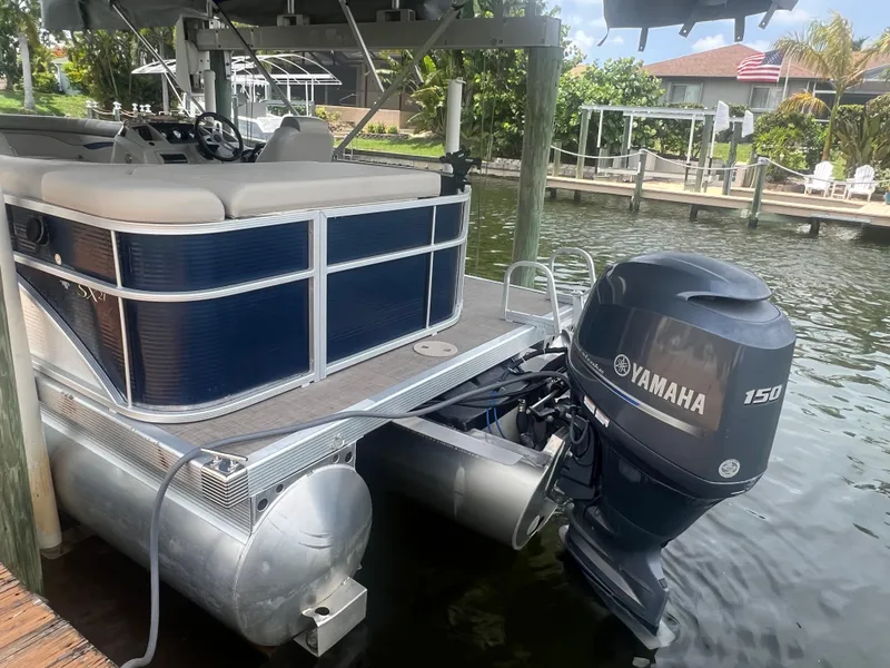 Slide: The Image of 2016 Bennington Sx pontoon boat with Yamaha 150 outboard motor docked. - 2