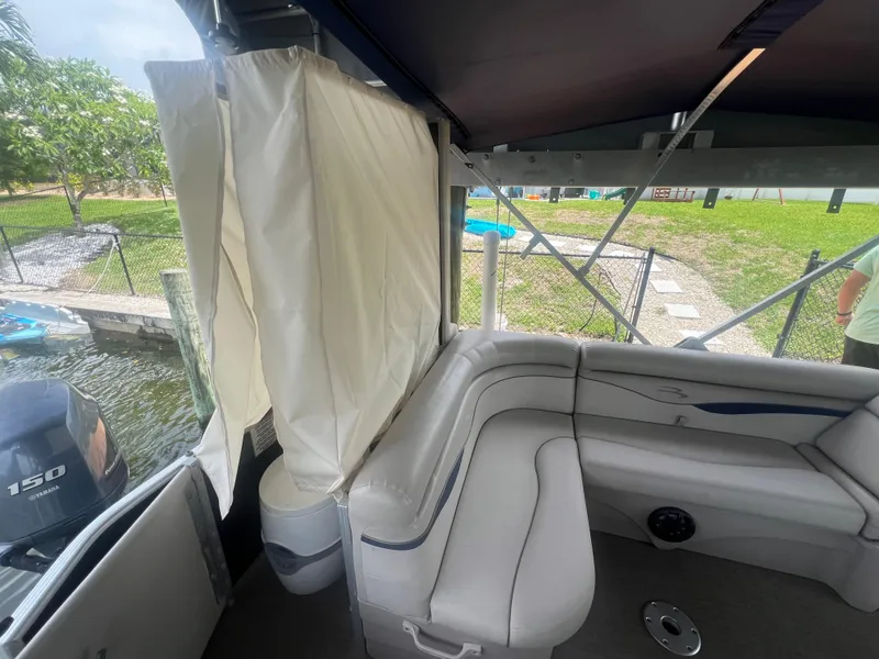 Slide: The Image of 2016 Bennington Sx boat interior with seating and privacy curtain. - 22