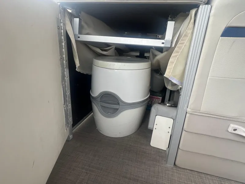 Slide: The Image of Portable toilet in 2016 Bennington Sx boat interior. - 23