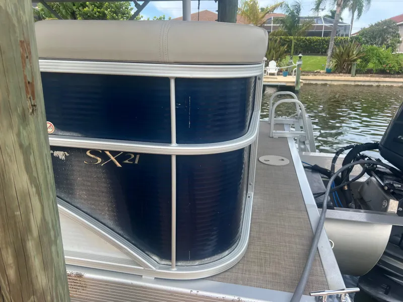 Slide: The Image of 2016 Bennington Sx21 pontoon boat docked by a canal. - 25